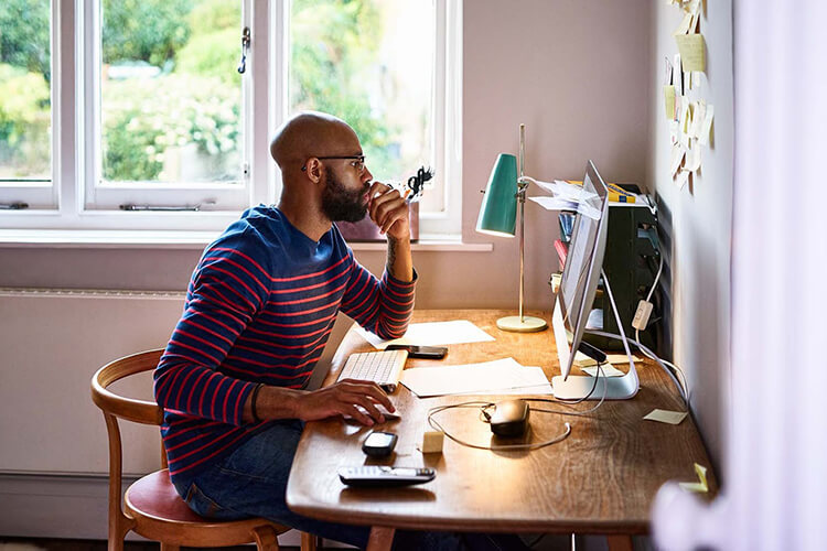 A man looking for a job on internet using Indeed website